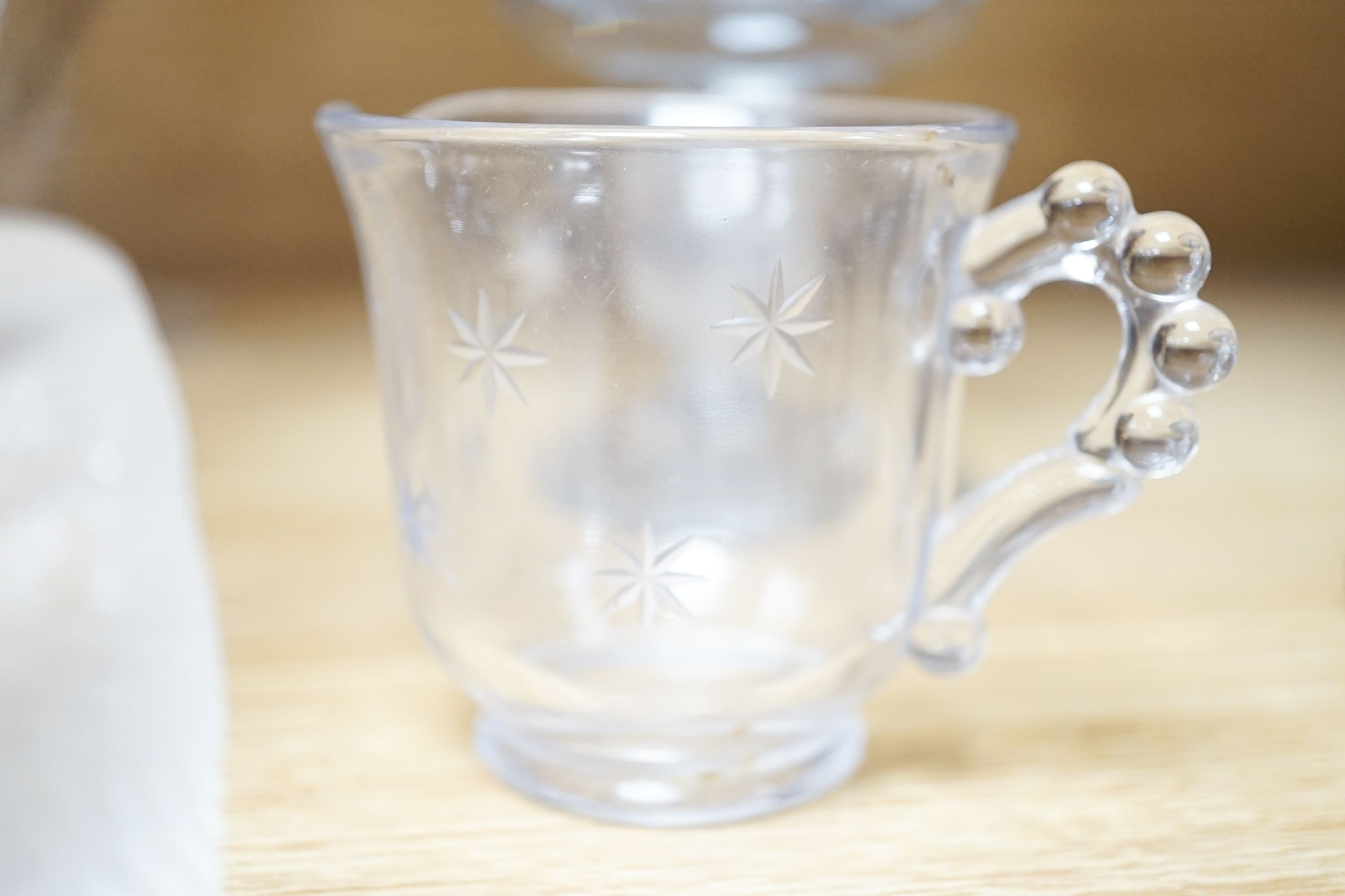 A Lalique frosted glass bird, etched Wedgwood ‘plant a tree ‘73’ glass, other etched glasses, decanters and blue glass pharmacy bottles